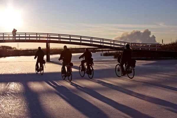 Cyclists on ice — Stockfoto