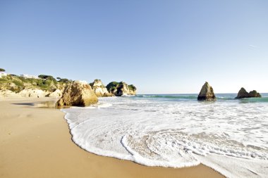 Rocky southcoast at Alvor in Portugal clipart