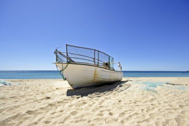 Fisherboat on the beach clipart