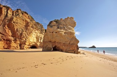 Huge rock on Praia da Rocha in Portugal clipart