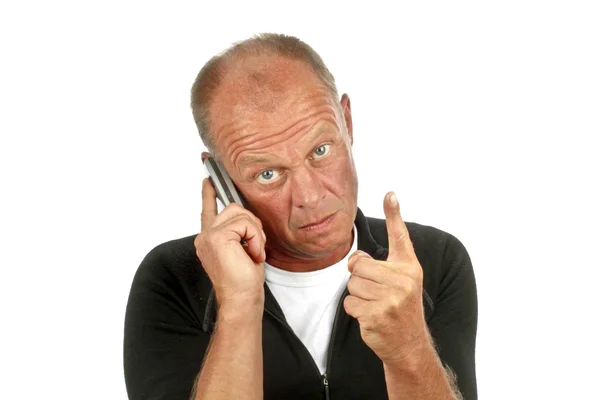 Homem fazendo um sinal de aviso enquanto fala ao telefone — Fotografia de Stock