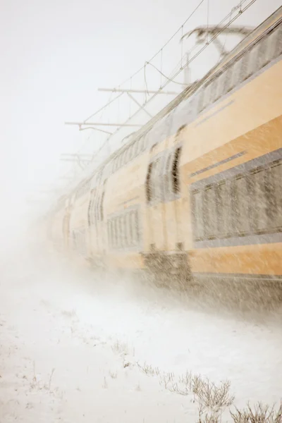 Full speed train driving in snowstorm in the countryside from the Netherlands — Stock Photo, Image