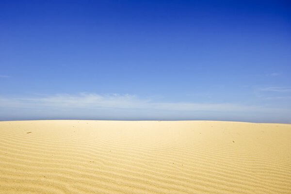 Песчаные дюны и голубое небо в Португалии
