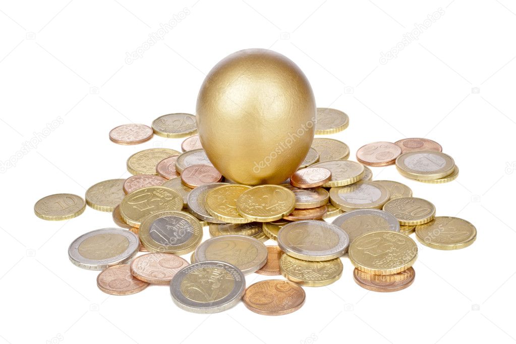 Golden egg on coins isolated on white