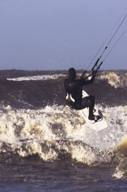Kite surfing on the north sea in Holland clipart