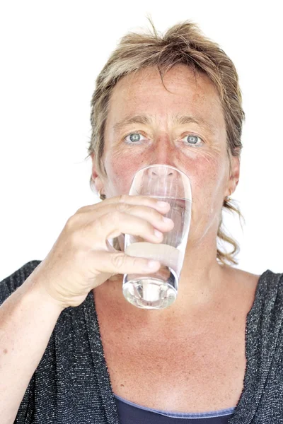 Mulher saudável de meia-idade bebendo um copo de água — Fotografia de Stock