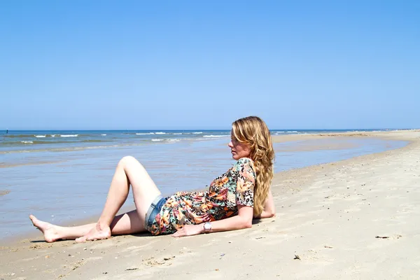 Hermosa mujer rubia relajándose en el paseo marítimo — Foto de Stock