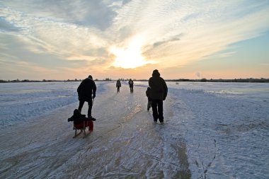Ice skating in the countryside from the Netherlands clipart