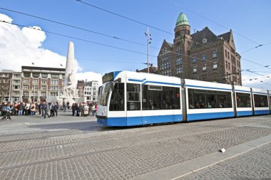 Tram driving at Dam square in Amsterdam the Netherlands clipart