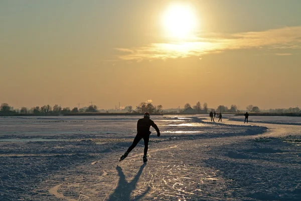 Ice skating in the countryside from the Netherlands at sunset — Stock Photo, Image