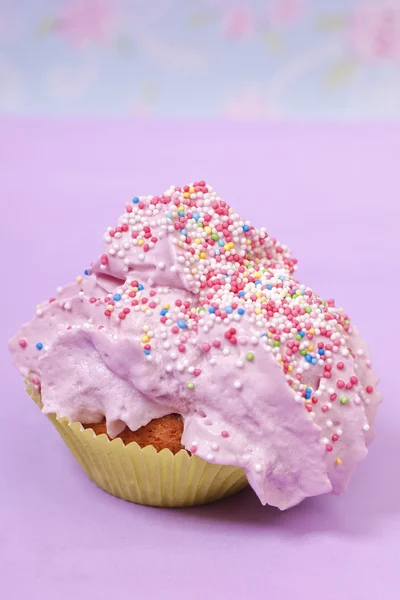 Pink cupcake with sprinkles — Stock Photo, Image