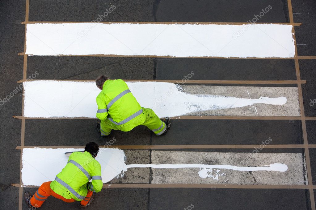 Workers painting crosswalk