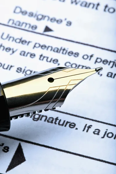 Stock image Pen and tax form