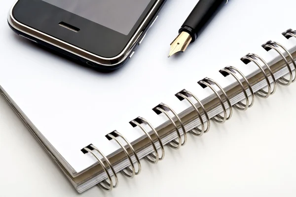 Pen, notebook and cell phone — Stock Photo, Image