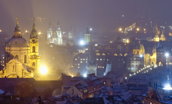 Czech republic, prague - illuminated spires of the old town and Nicolaus church