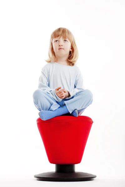 Ragazzo seduto su uno sgabello rosso — Foto Stock