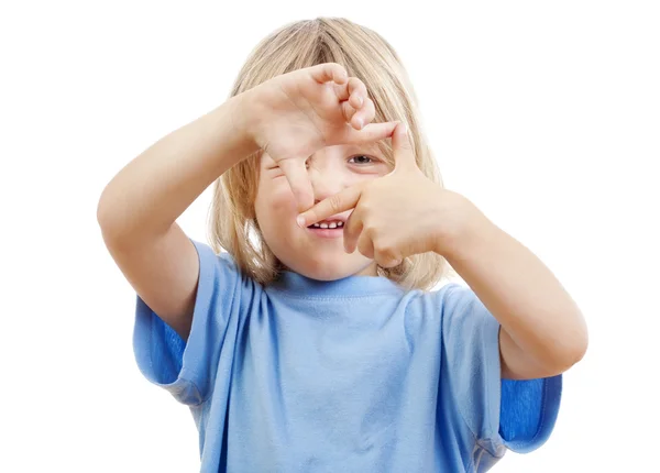 Boy looking through finger frame — Stock Photo, Image