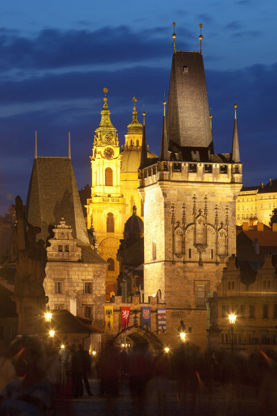 Czech republic prague - charles bridge tower and st. nicolas church at dusk