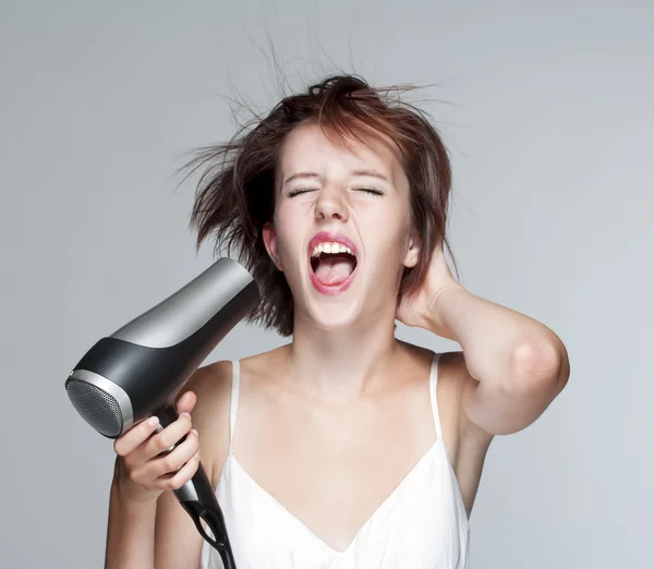 Menina com secador de cabelo — Fotografia de Stock