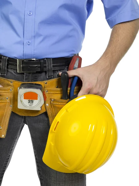 Un travailleur avec casque jaune et outils de construction — Photo
