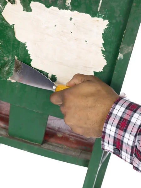 Bilden av en hand peeling färg med mejsel — Stockfoto