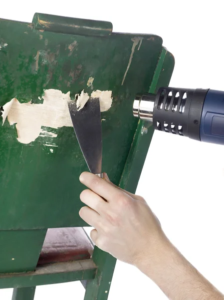 Удаление краски с помощью теплового пистолета и лопатки — стоковое фото