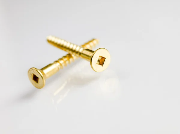 Two gold screws — Stock Photo, Image