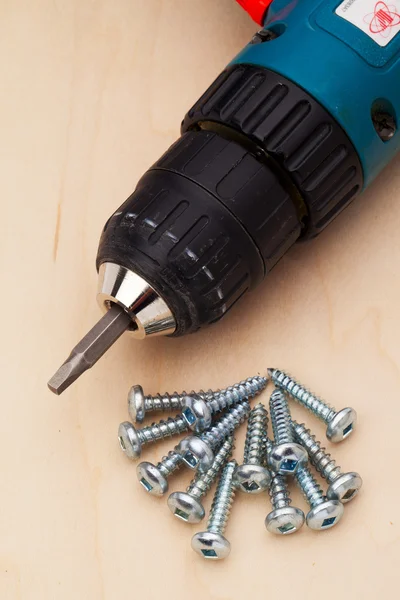 Powerdrill and a few screws — Stock Photo, Image