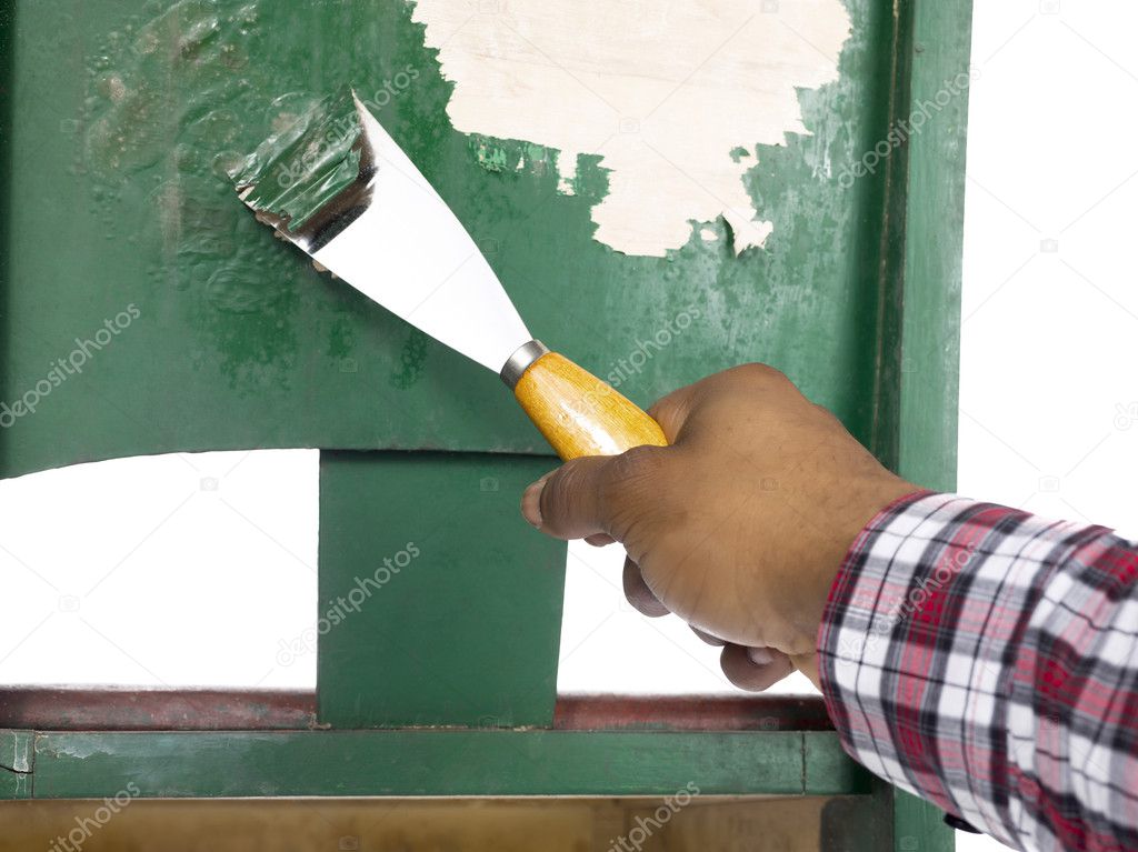 Person removing paint with chisel