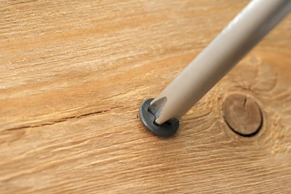 Screw in wooden plank — Stock Photo, Image