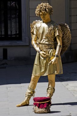 Living statue - a man in the image of Cupid clipart