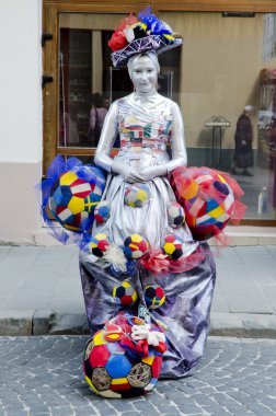 Living statue - girl in the image of a soccer fan clipart