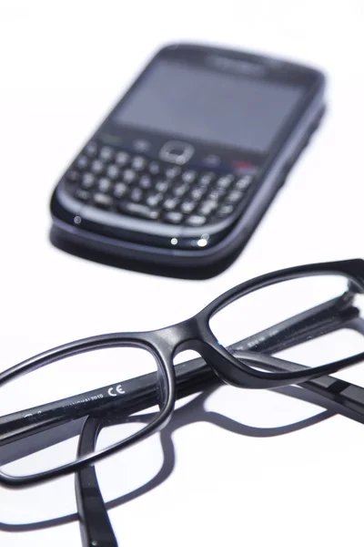 stock image Black glasses and cell phone