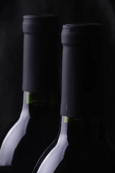 stock image Bottles of red wine on black