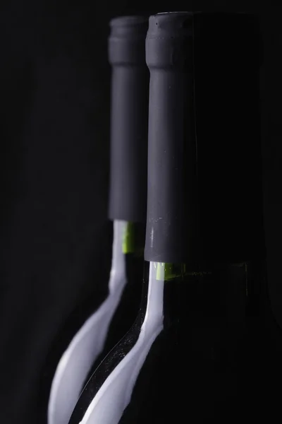 stock image Bottles of red wine on black