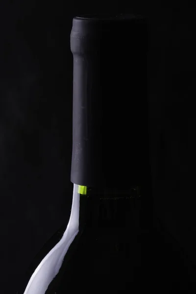 Bottles of red wine on black — Stock Photo, Image