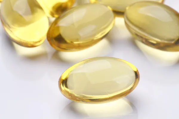 Žlutá pilulky vitaminu e měkké gely — Stock fotografie