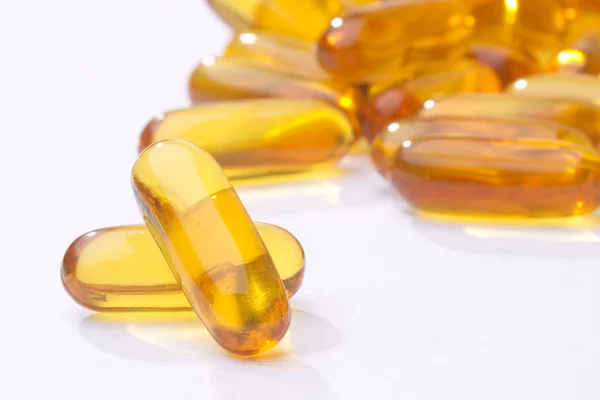 A bunch of yellow gel pills-fish oil — Stock Photo, Image