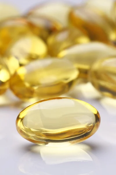 Yellow Pills Vitamin Soft Gels - fish oil Stock Photo