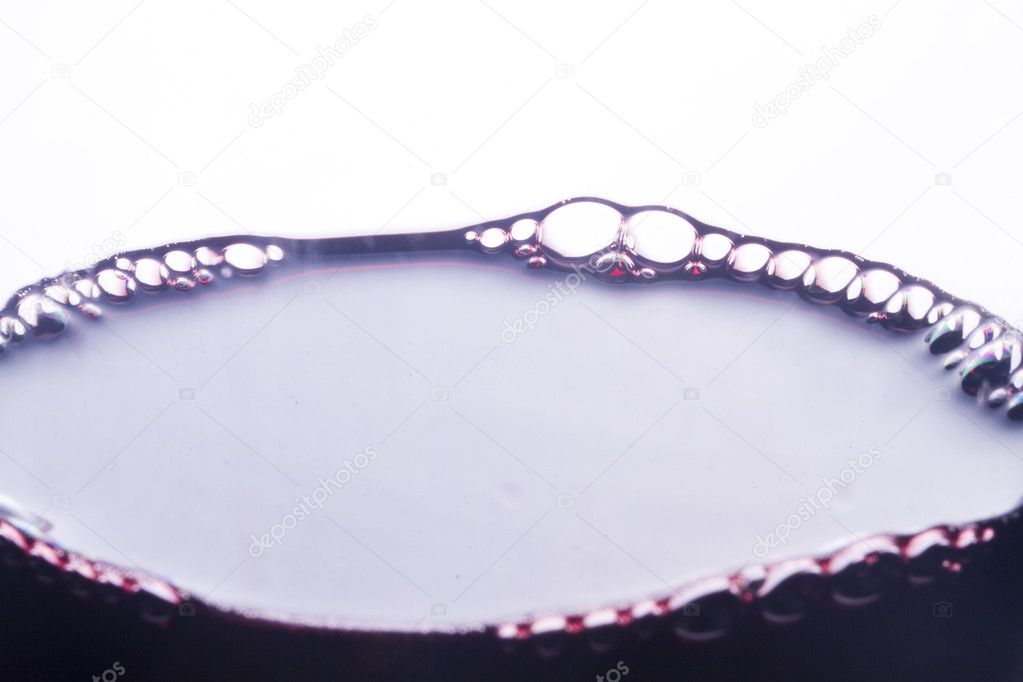 Bubbles of red wine in glass