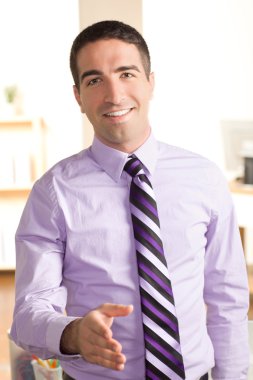 Good looking business man shaking hand clipart