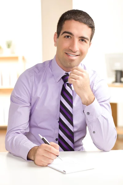 Attractive guy writing — Stock Photo, Image