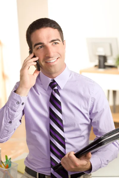 Cute guy on phone with leather pad — Stock Photo, Image