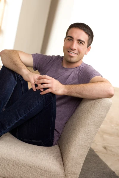 Handsome guy sitting on chair — Stock Photo, Image