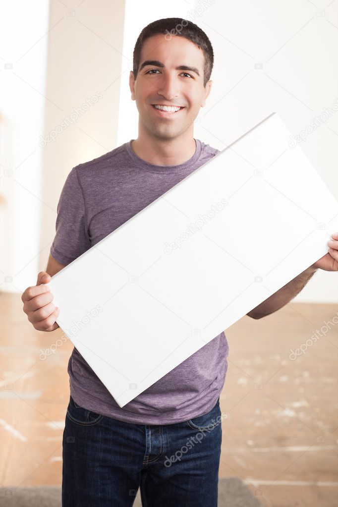 Cute guy holding blank sign