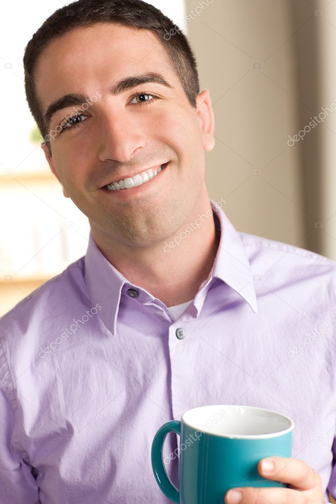 Cute man smiling with cup