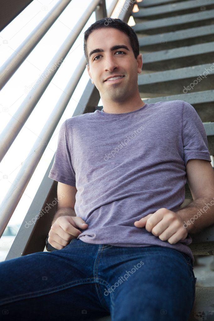 Sexy guy on stairs outdoors