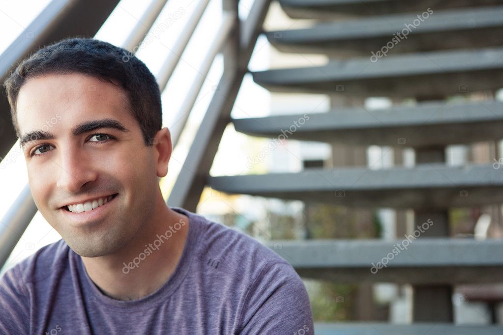 Sexy guy smiling on stairs