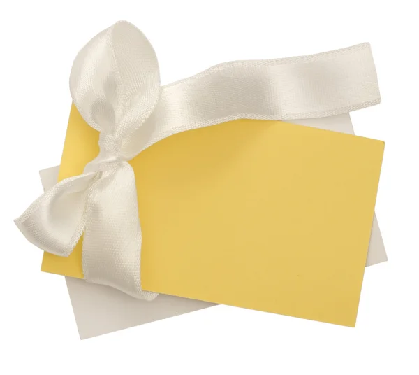 Yellow note with the white bow — Stock Photo, Image