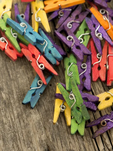 Colorful clothing pins on the wooden table — Stock Photo, Image